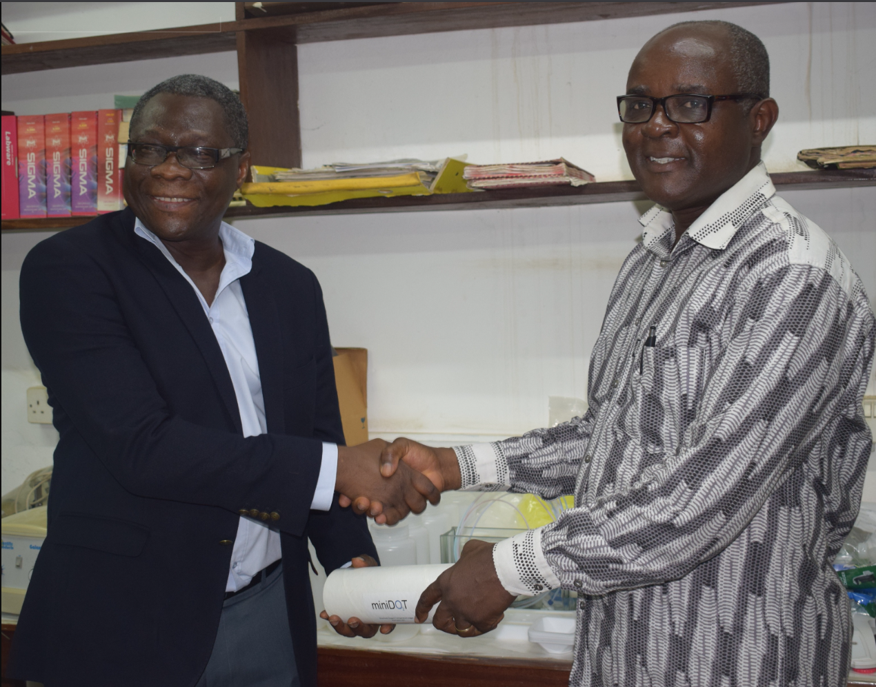       Prof. Asiedu handing over the equipment received from the Research Team Prof. Kwasi Appeaning Addo (Director, IESS)