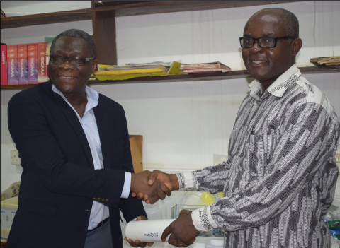 Prof. Asiedu handing over the equipment received from the Research Team Prof. Kwasi Appeaning Addo (Director, IESS)